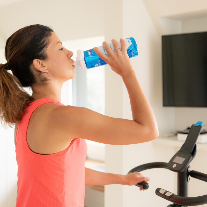 Woman drinking water during a workout session