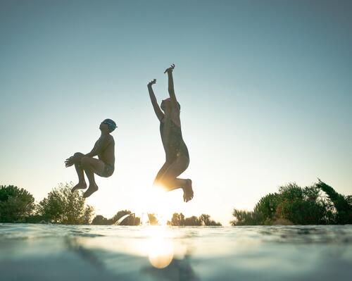 Picture of kids jumping to a pool