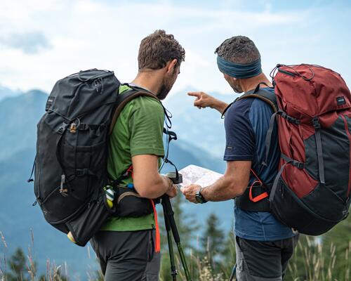 Two men checking map while hiking