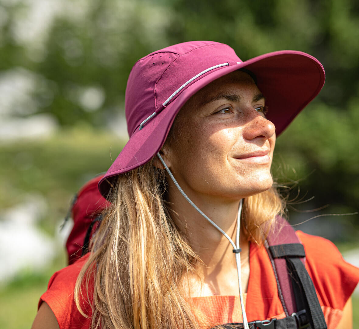 Woman hiking with a hat for sun protection