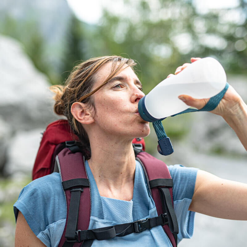 woman drinking water on a hike
