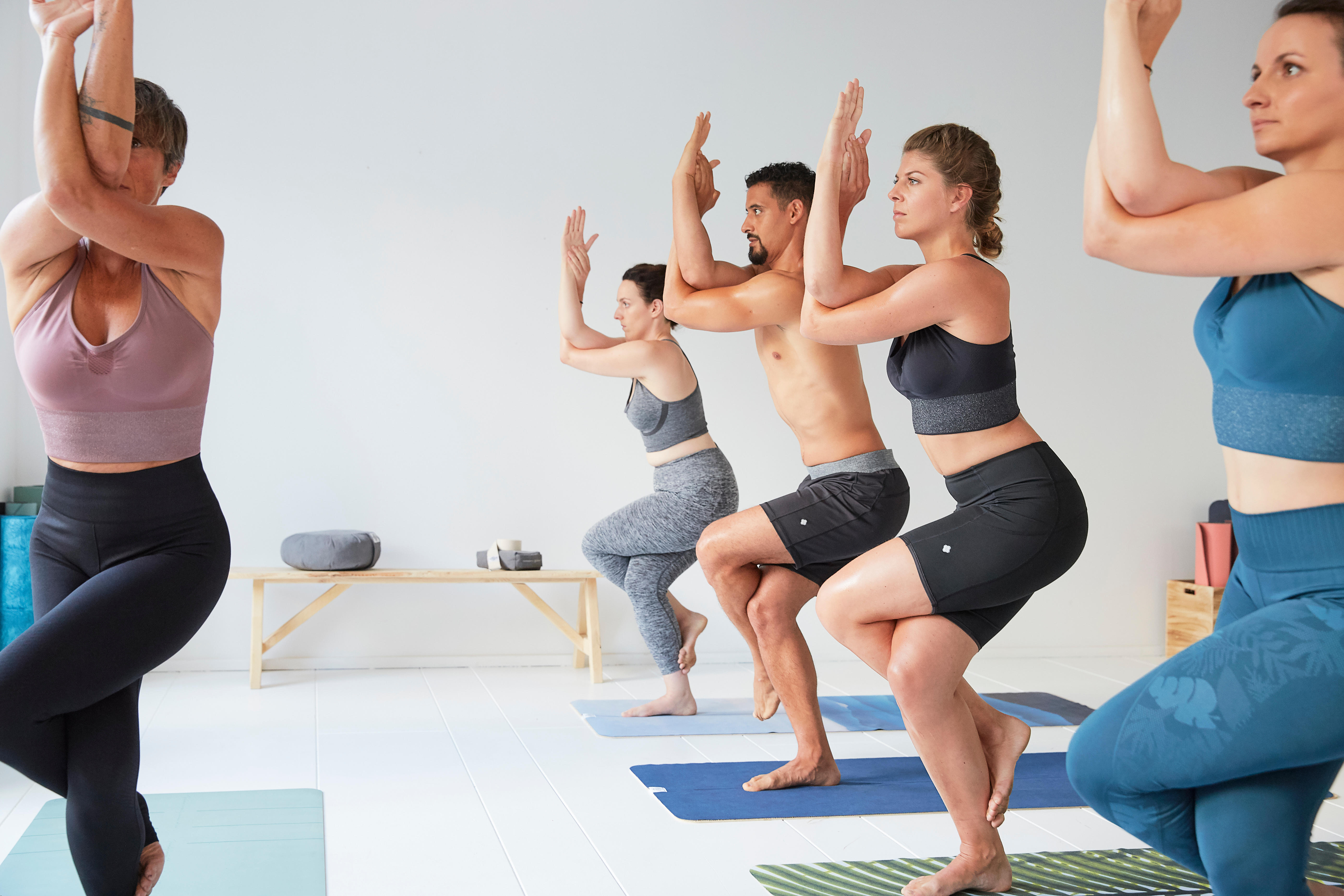 two happy slim women with yoga mat, towels and bottles of water