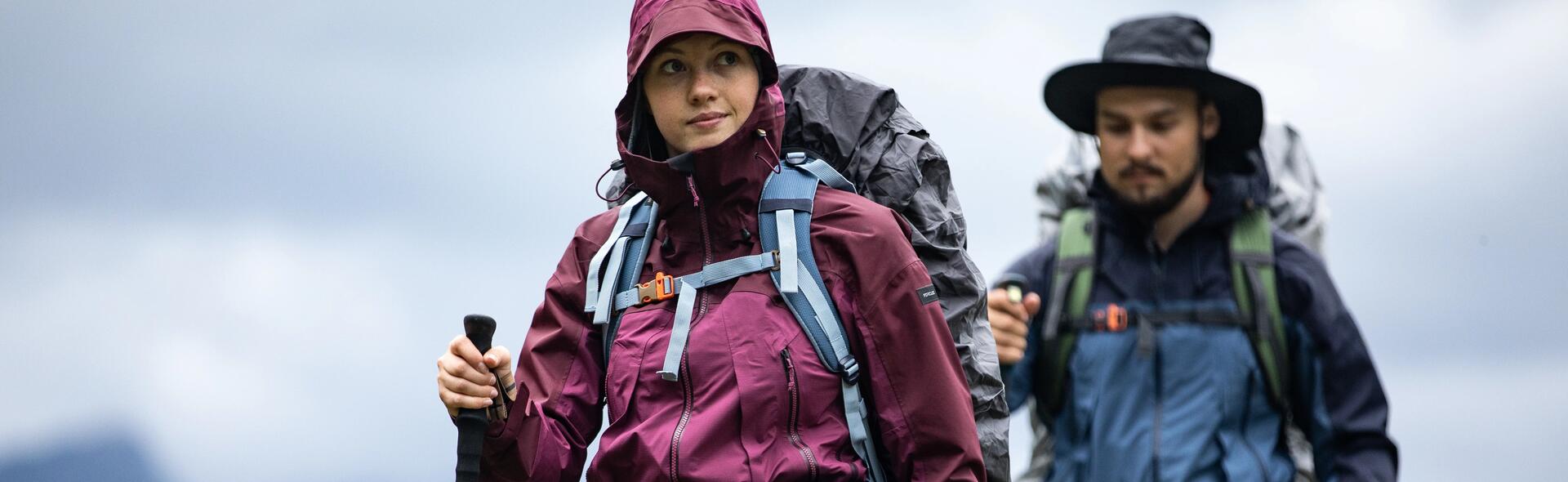 Two people walking with their hiking equipment