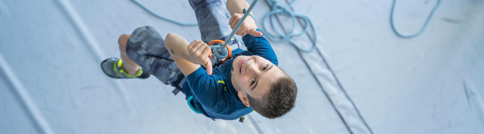 little boy climbing with thumbs up