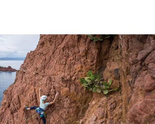 Woman using climbing cord on mountain climb.