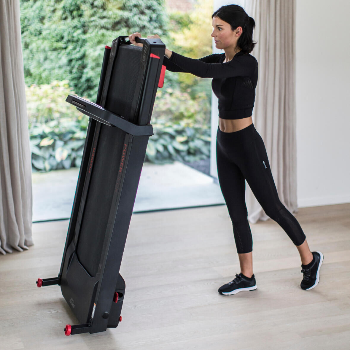 woman folding her treadmill