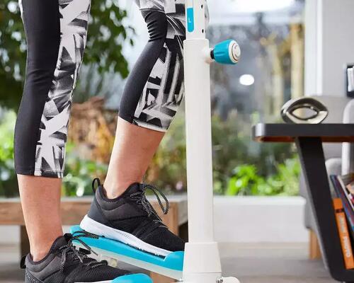 Blue stepper in the living room being used by a women.