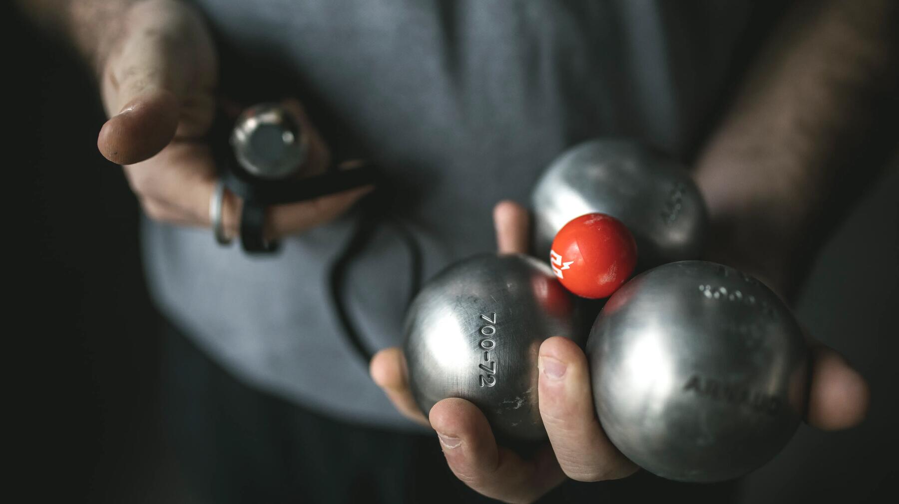 Iemand met drie boules en een butje in de hand