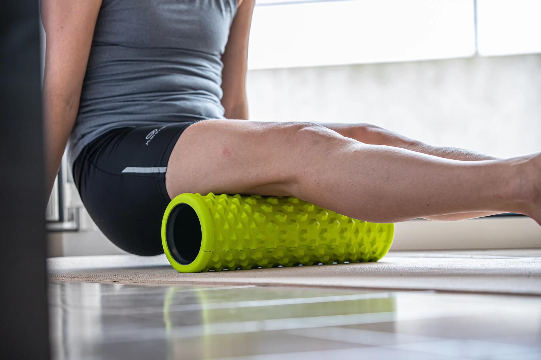 mujer liberando isquiotibiales con foam roller