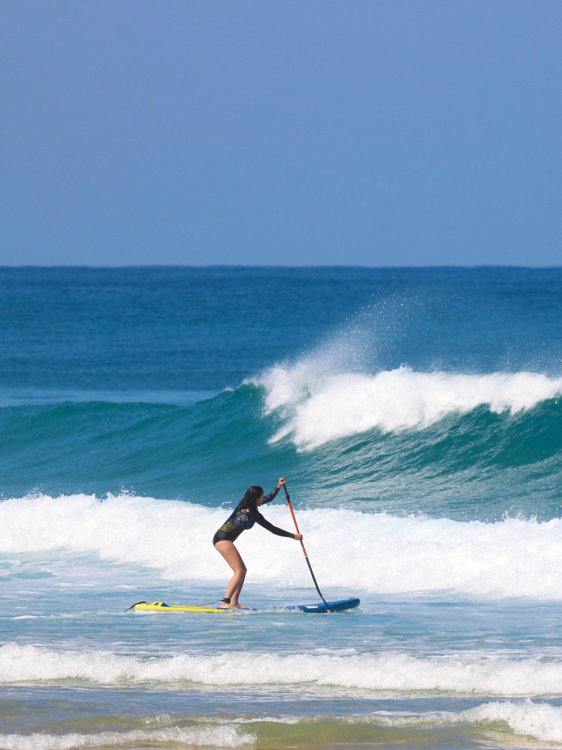 Standing on shop surfboard paddling