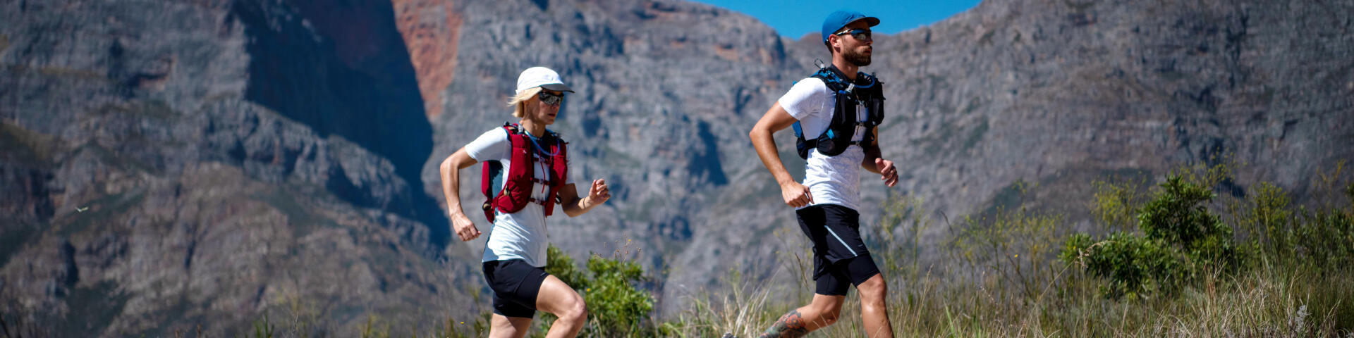a man and a woman running in hot weather on the mountain
