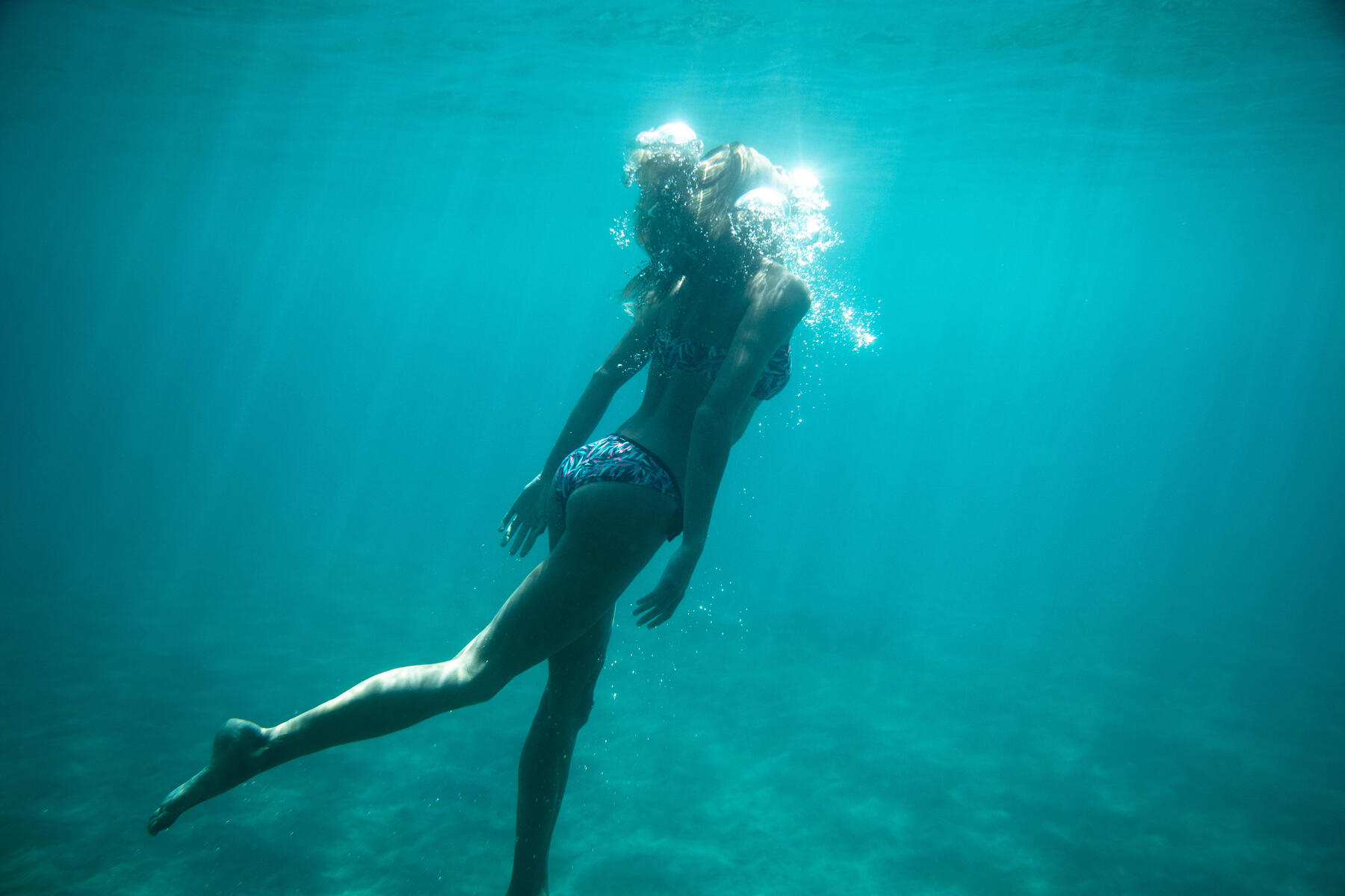 Olaian swimming in the sea with a surf bikini
