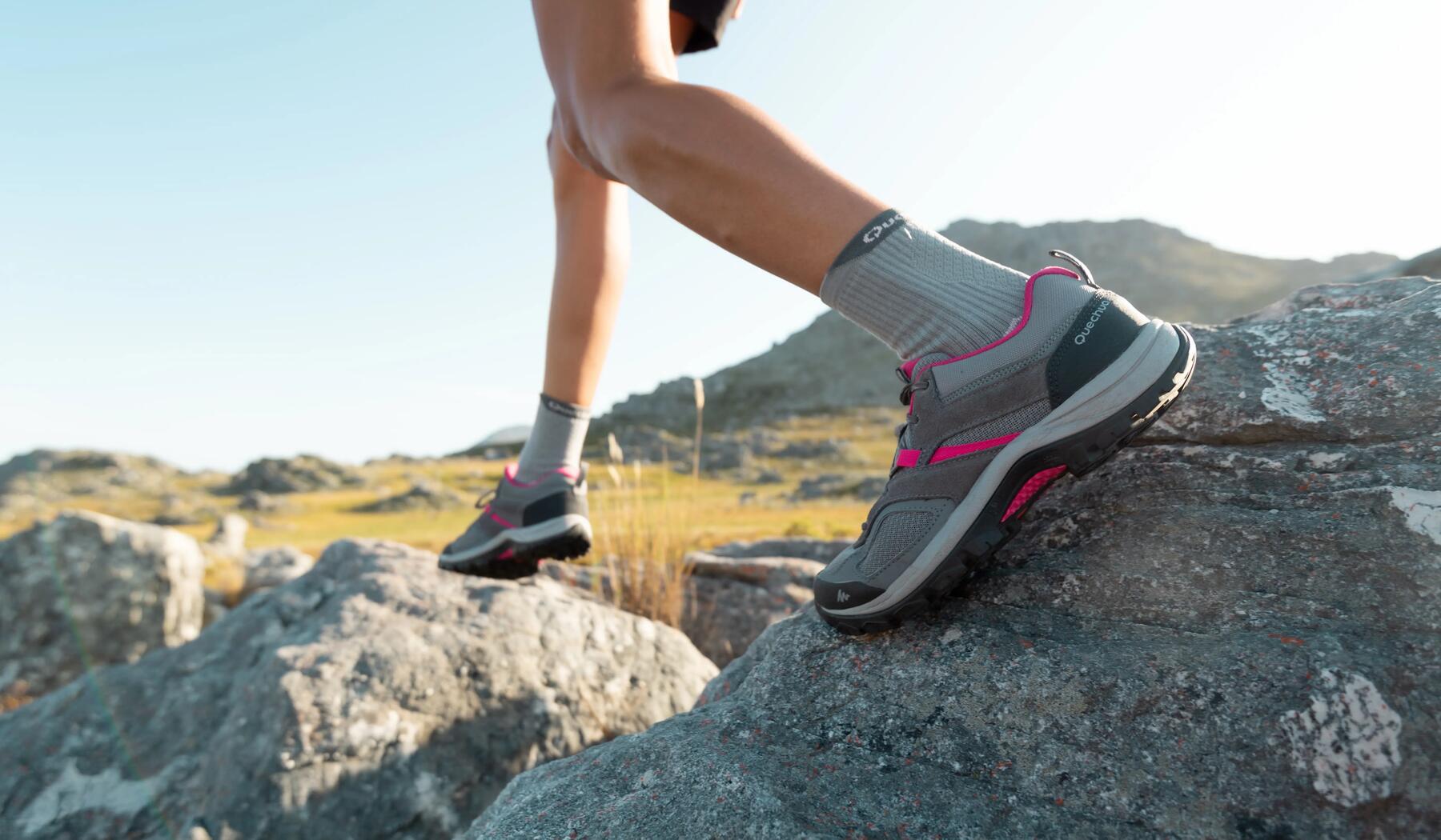 close-up of person walking on rocky terrain