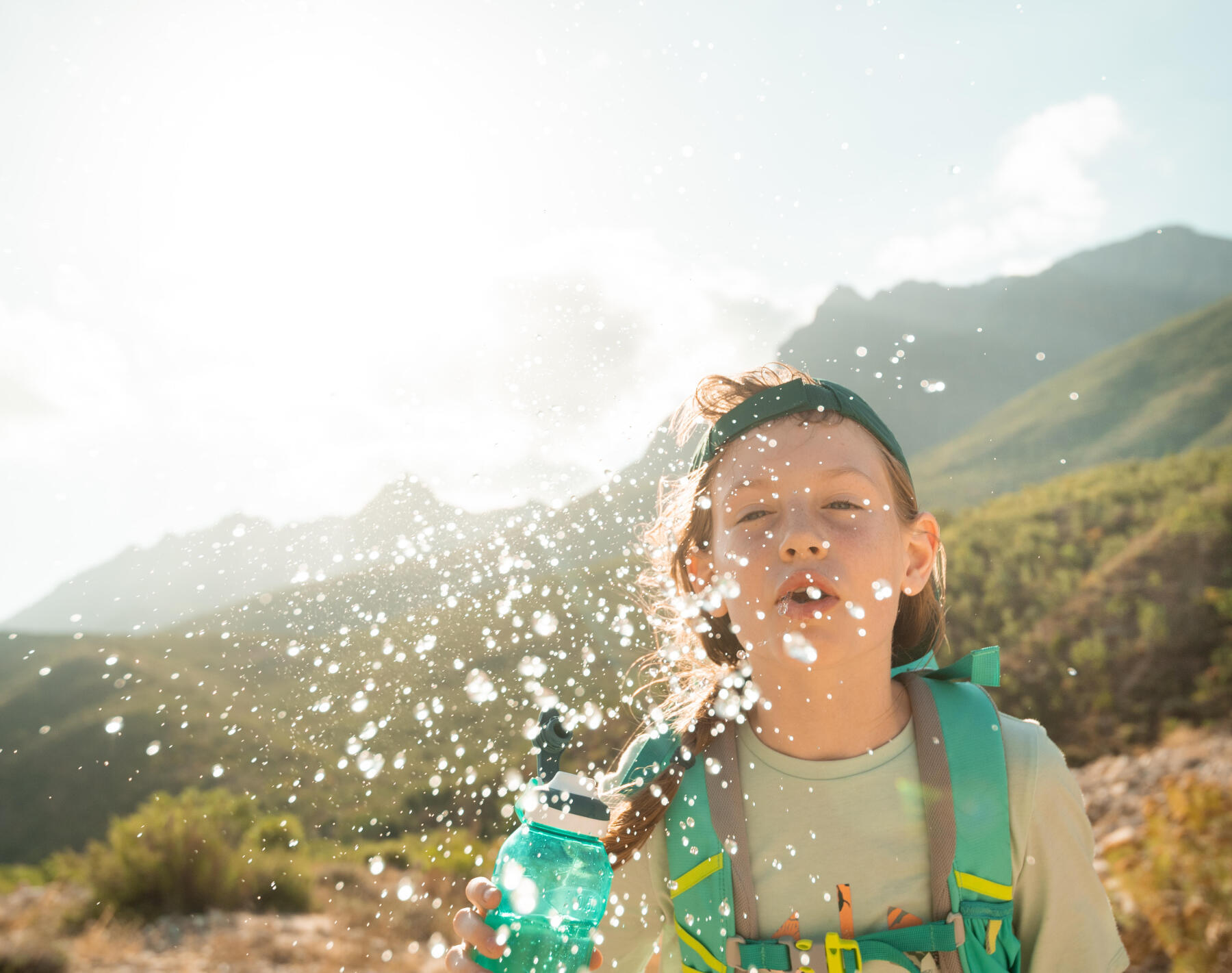 little boy slashing water with his bottle