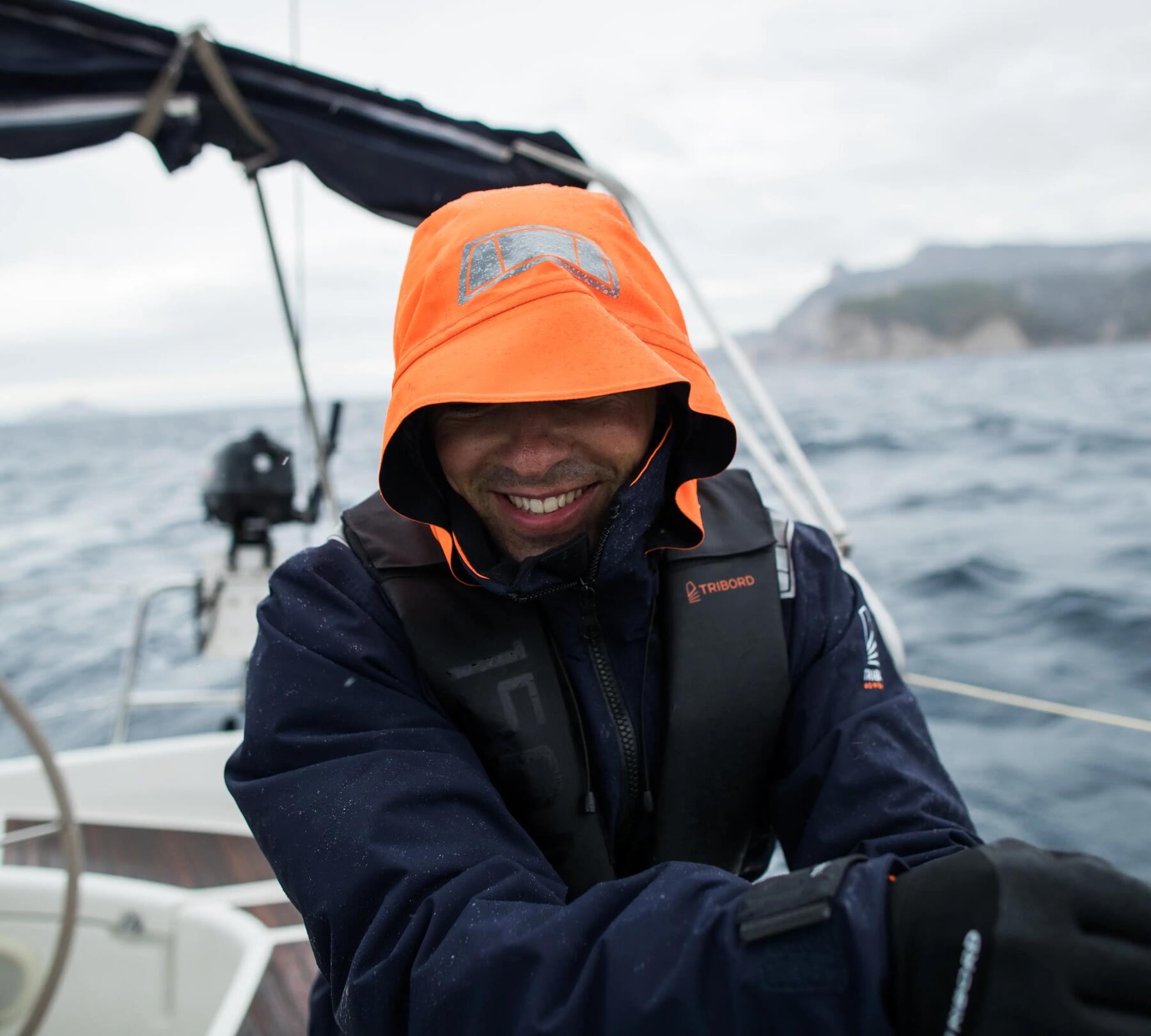 Man on boat, smiling, wearing life jacket