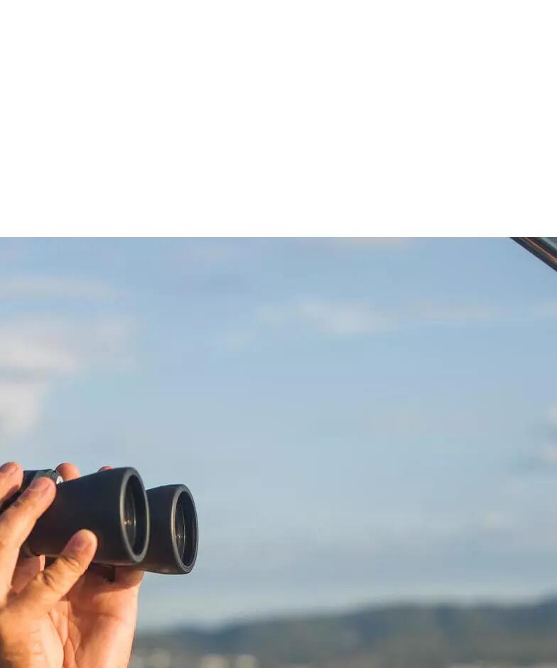 Man looking through binoculars