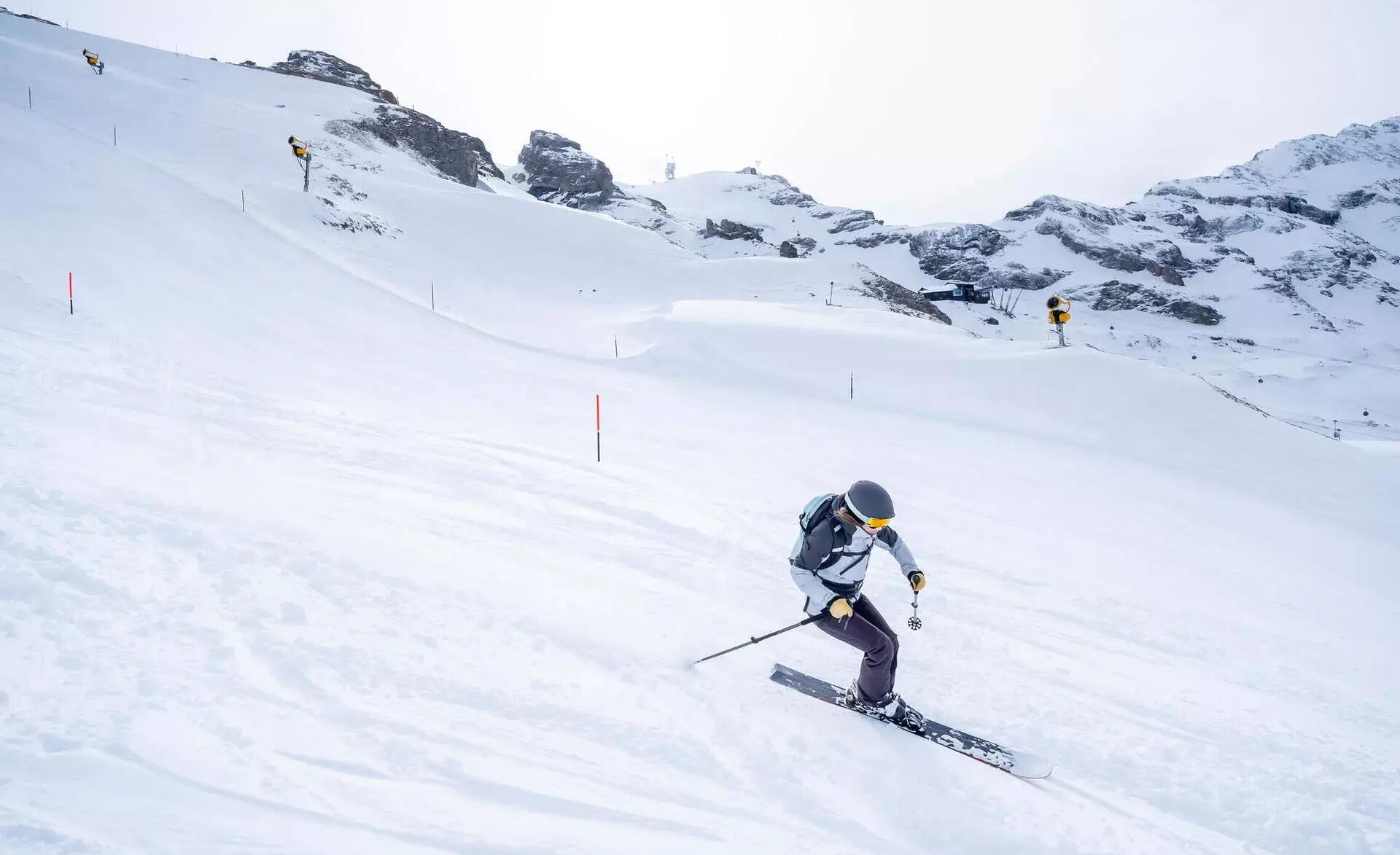 A free ride skier going down a fresh powdered ski slope