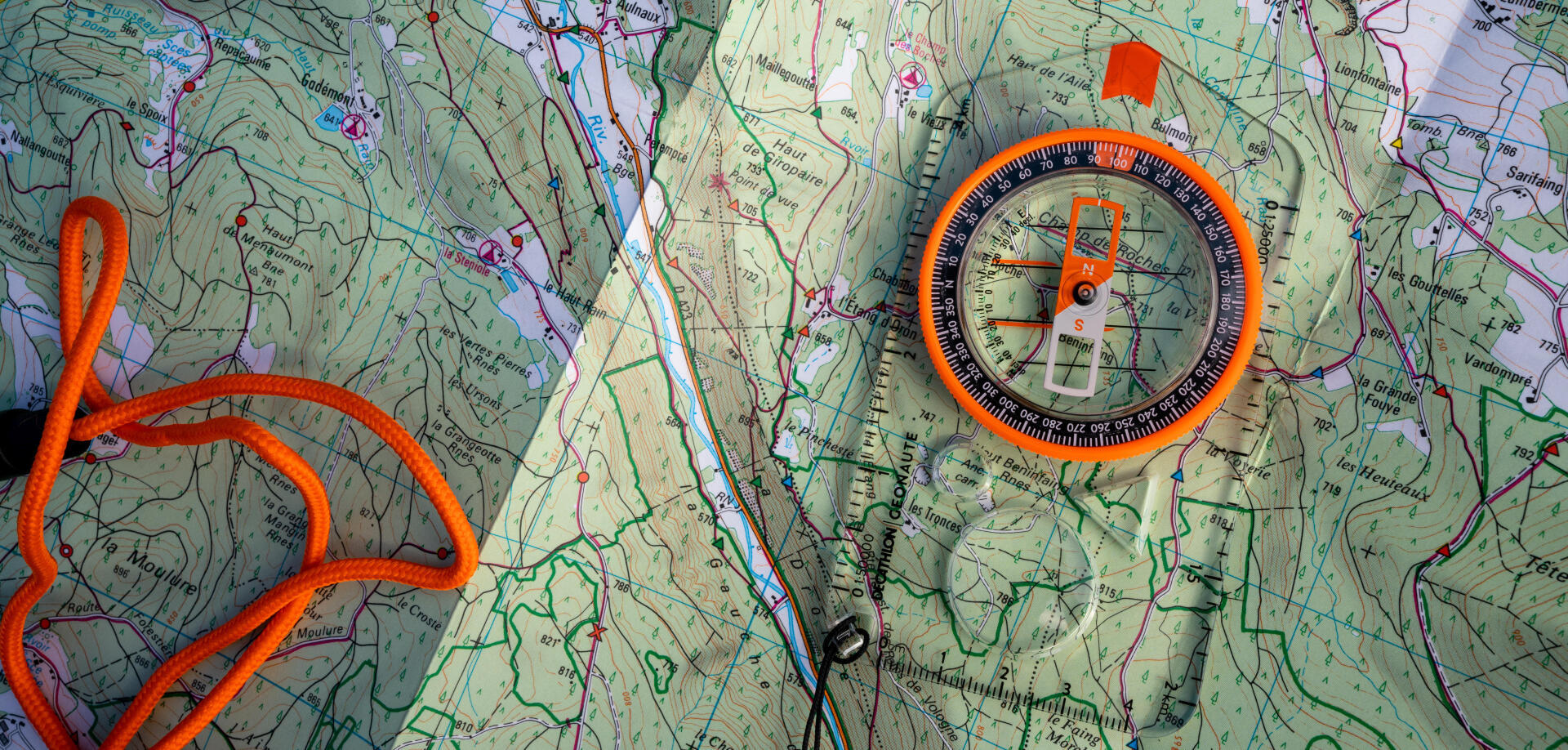 Man explorer searching direction with compass for map