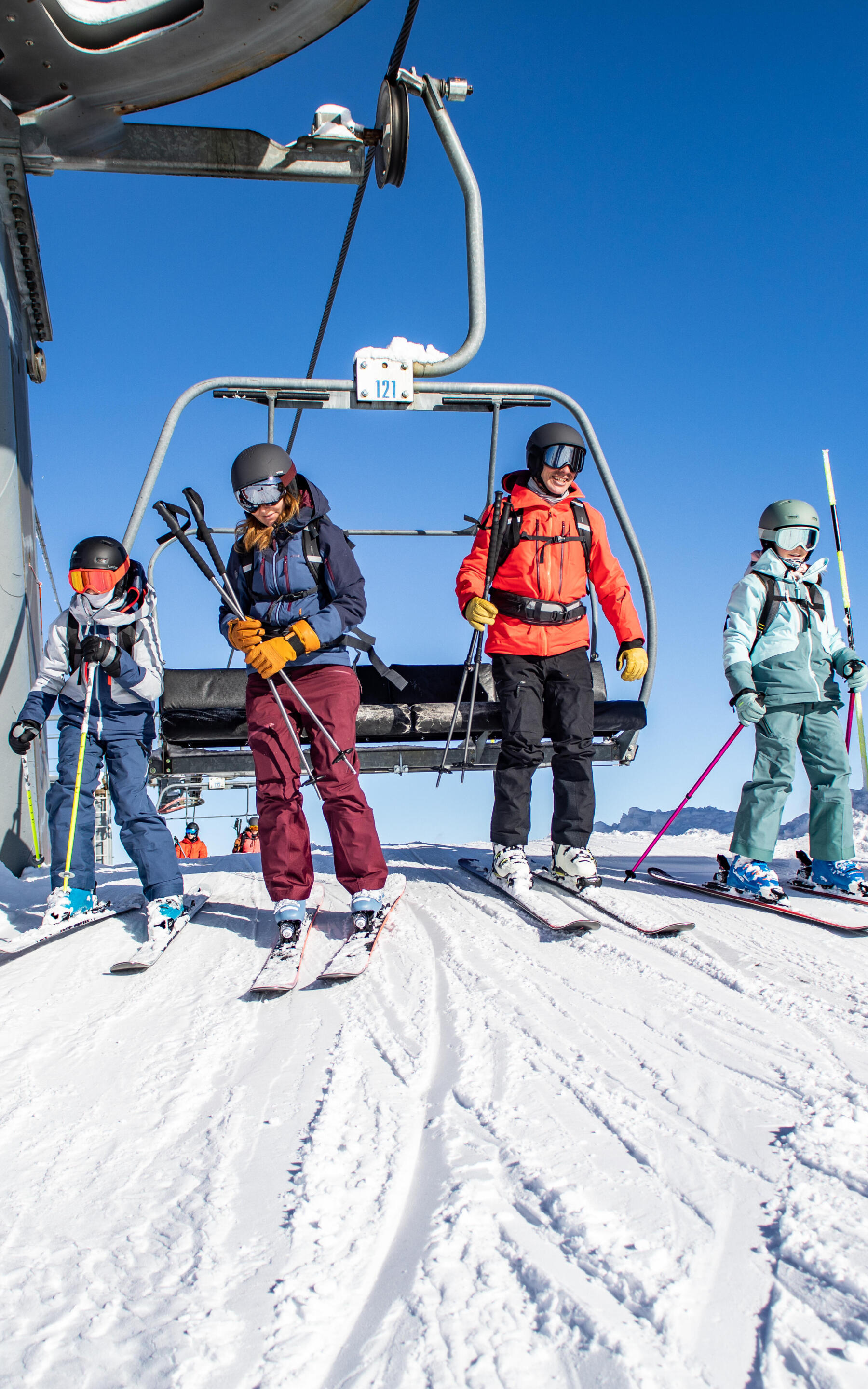 Four friends coming out of the chairlift.