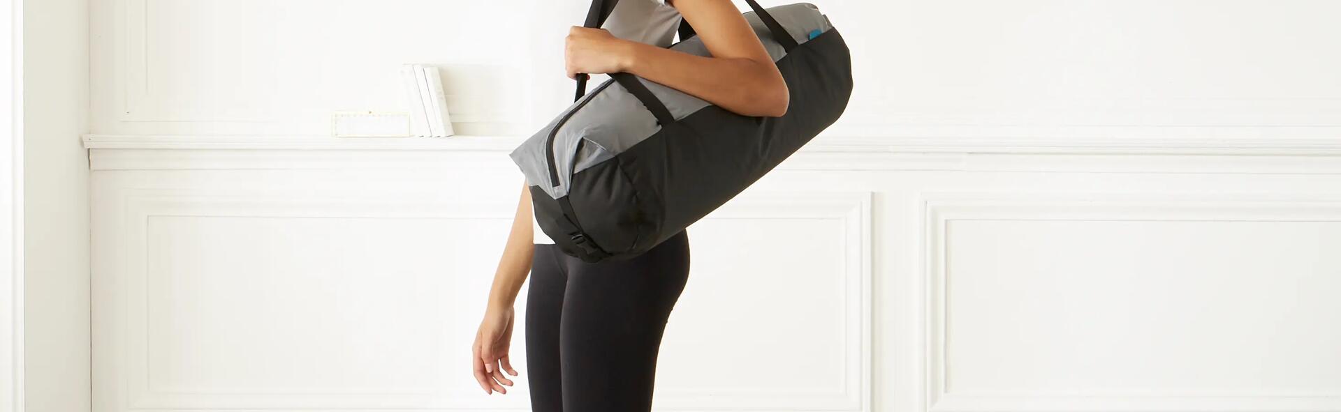 kobieta w stroju do pilatesu trzymająca torbę sportową