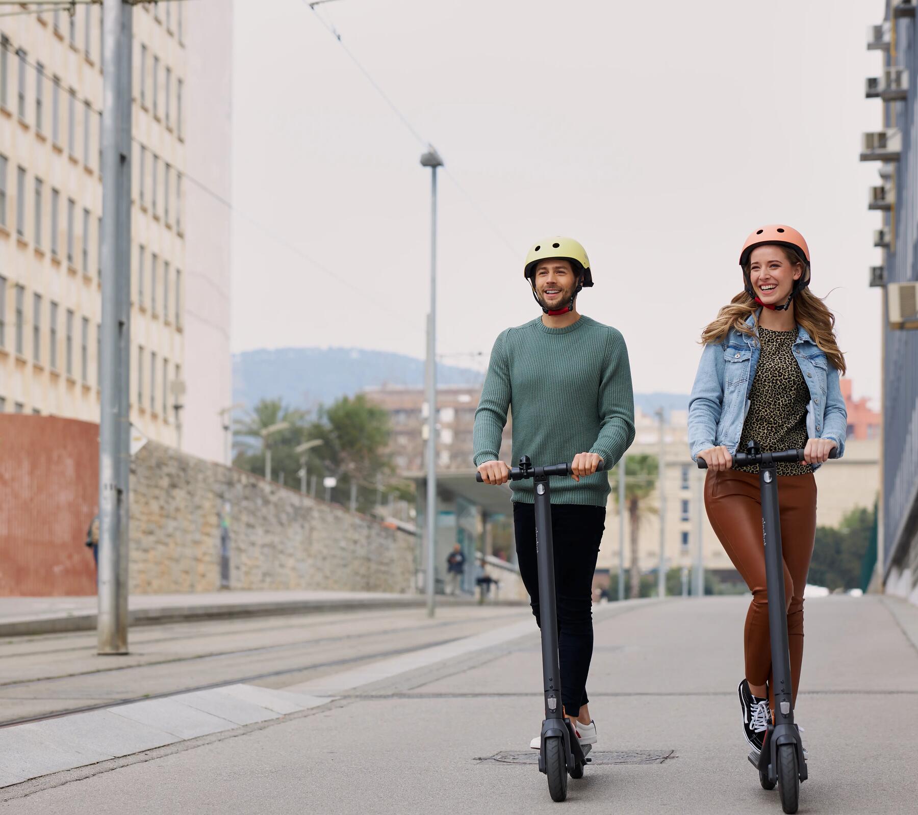 Man and woman scootering