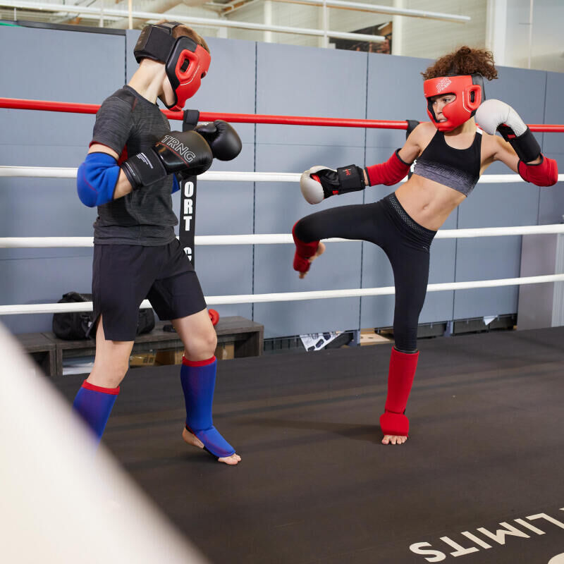 A boxer in the ring attacking her opponent
