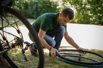 Man changing a bicycle inner tube