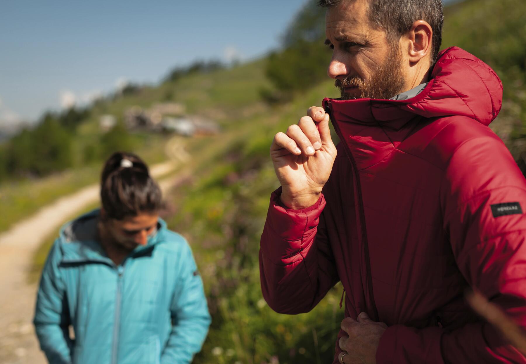 Mand and woman standing on trail wearing down jackets