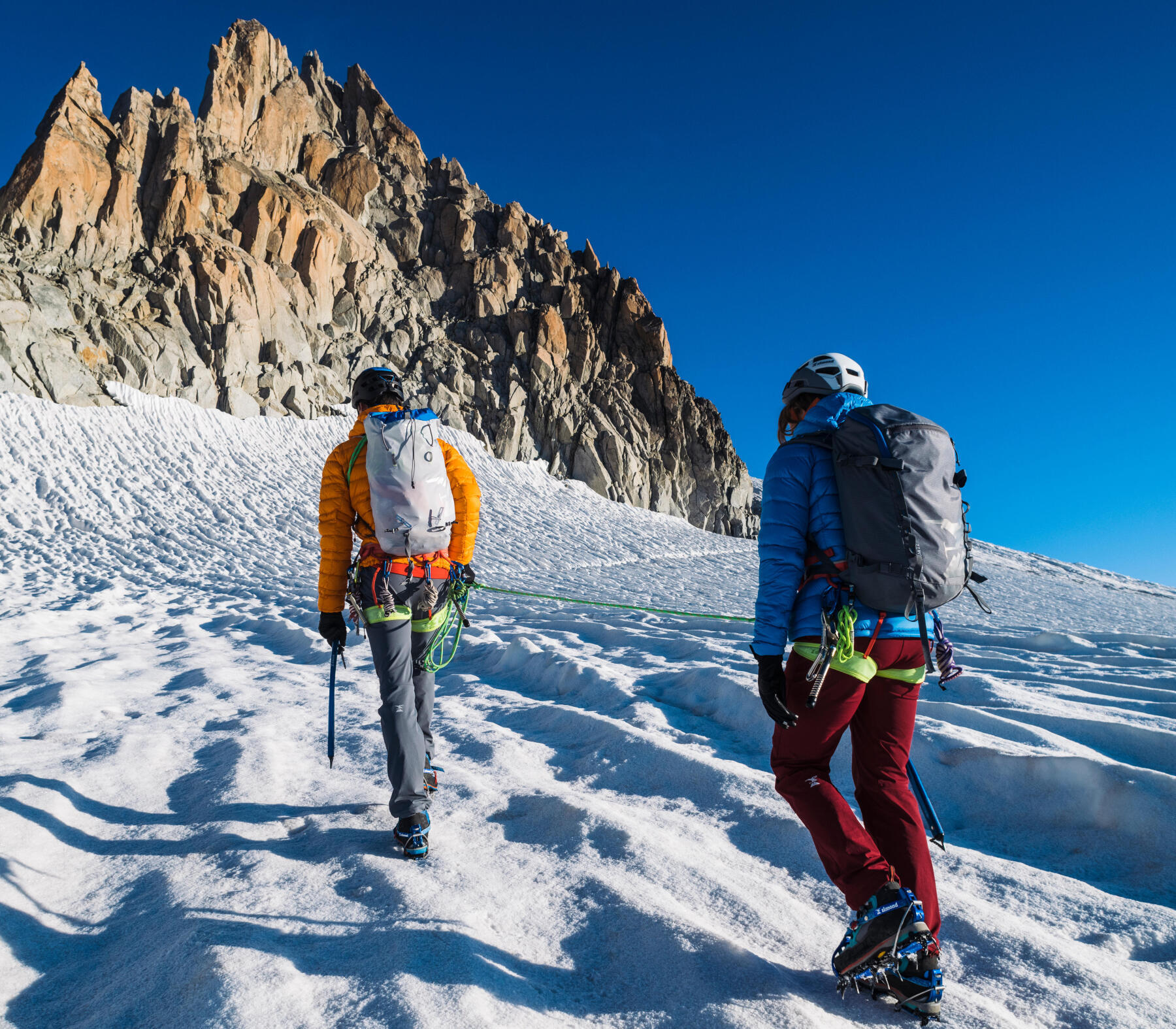 two alpinist glacier hiking 