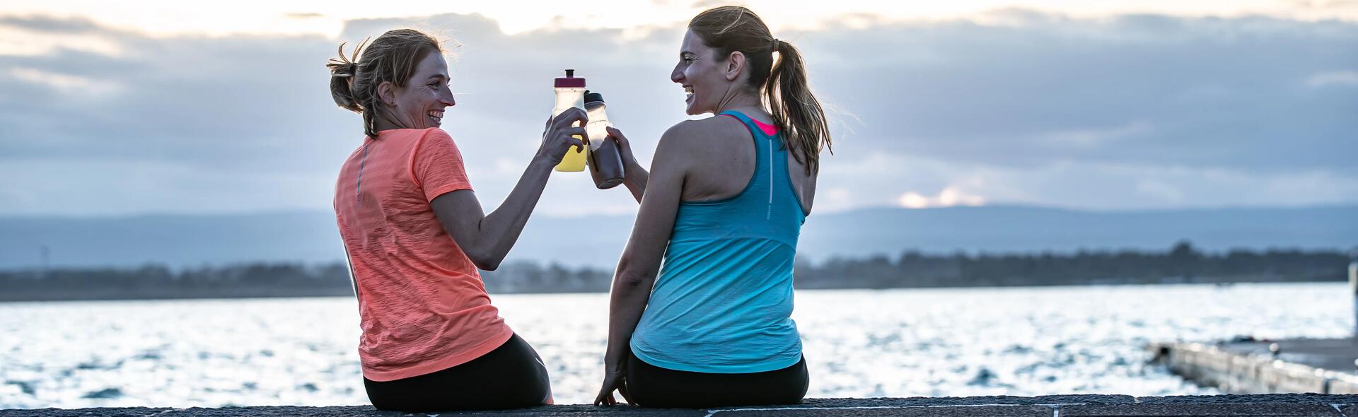 2 ladies using recovery drinks after sports