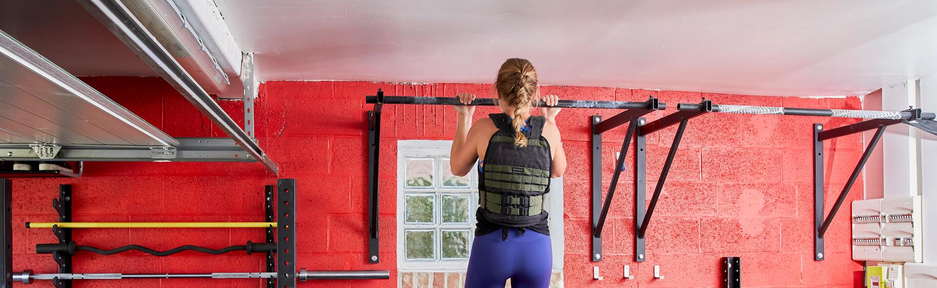 woman doing chin ups with weighted vest