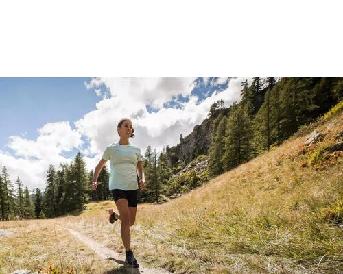 Close up for person running on trail. 