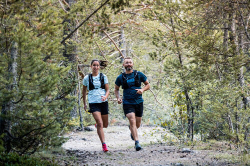 two people running in the forest