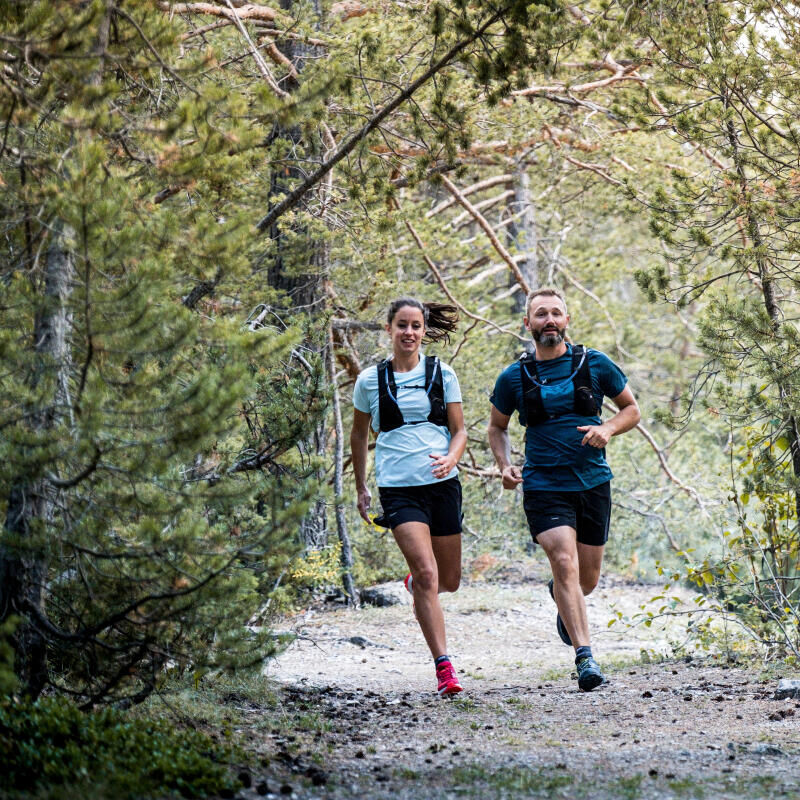 two people running in the forest