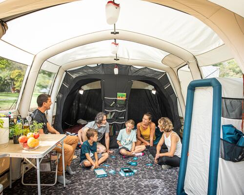 Family camping, talking and playing cards