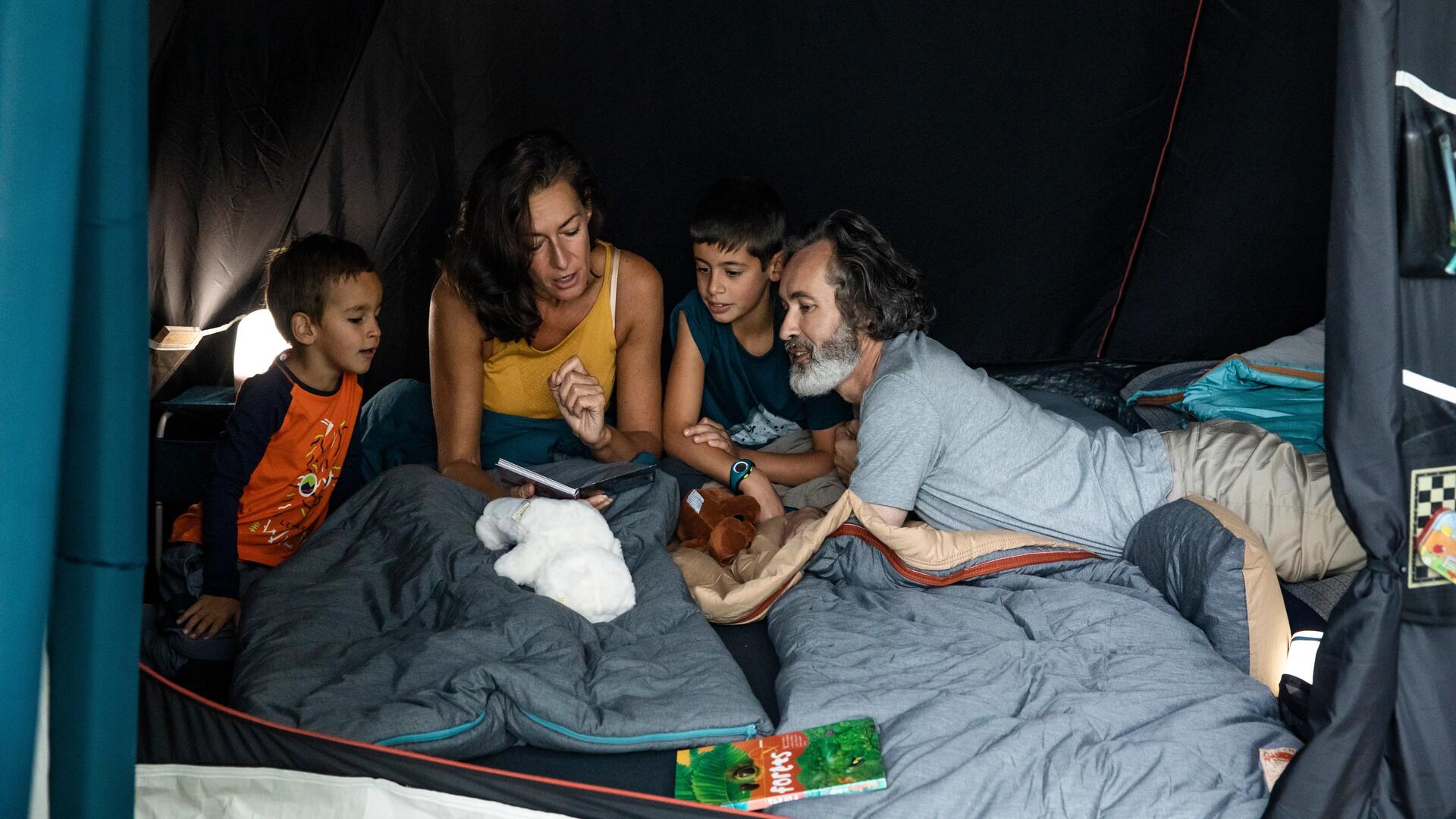 A family of campers inside a tent 