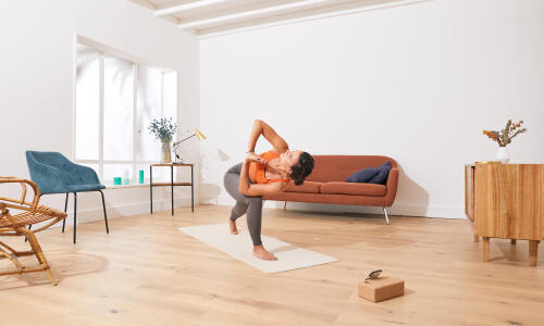 a woman doing yoga in her living room