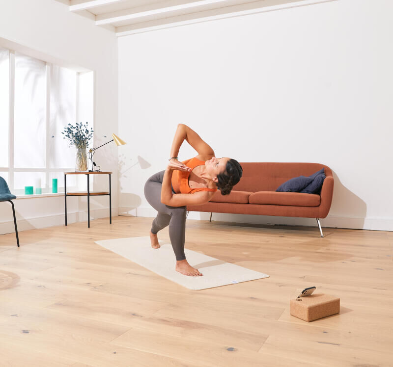 a woman doing yoga in her living room