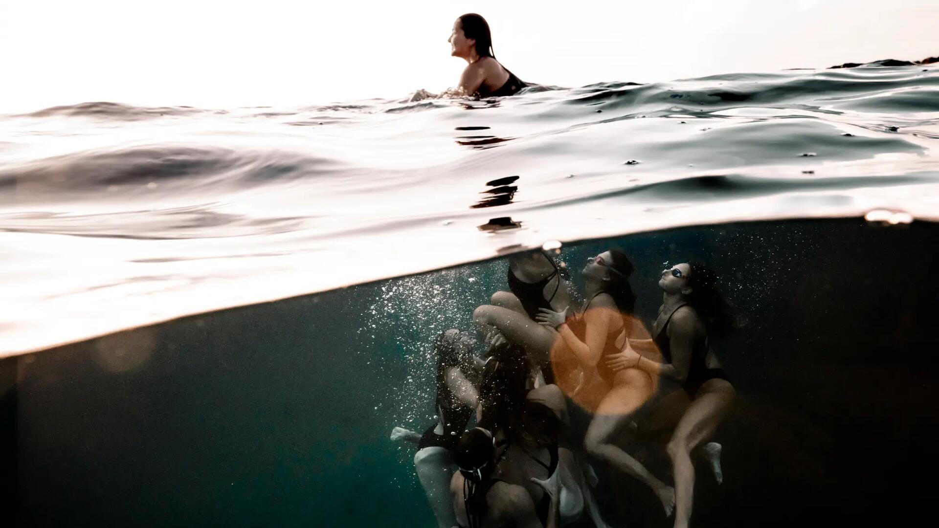 Picture swimmer with stingrays