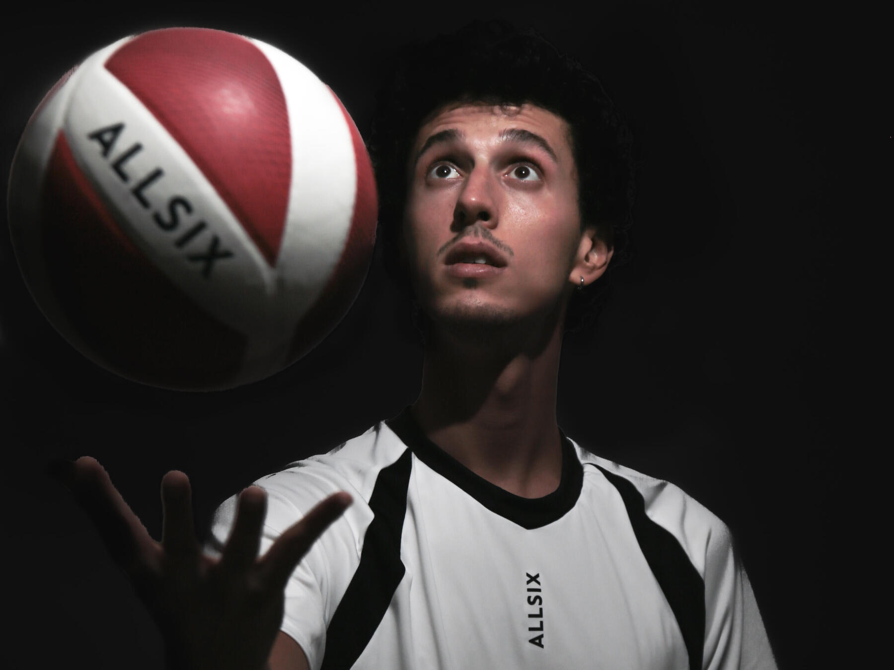 homme devant un ballon de volleyball V900 Allsix