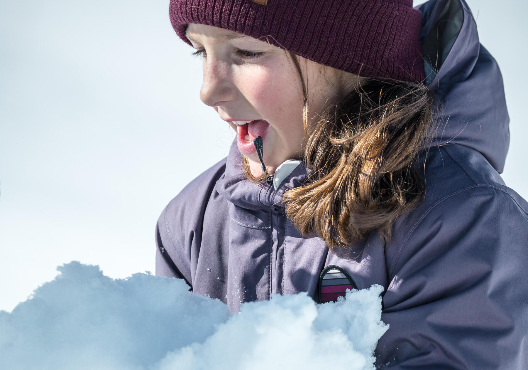 young girl playing in the snow