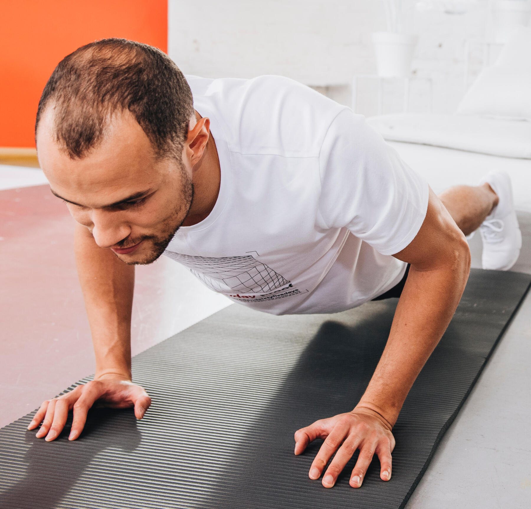 man doing at-home pilates on a yoga mat