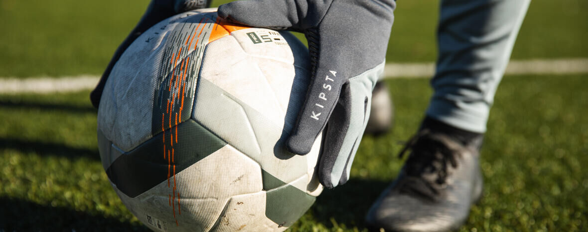 close-up on a player picking up a soccer ball