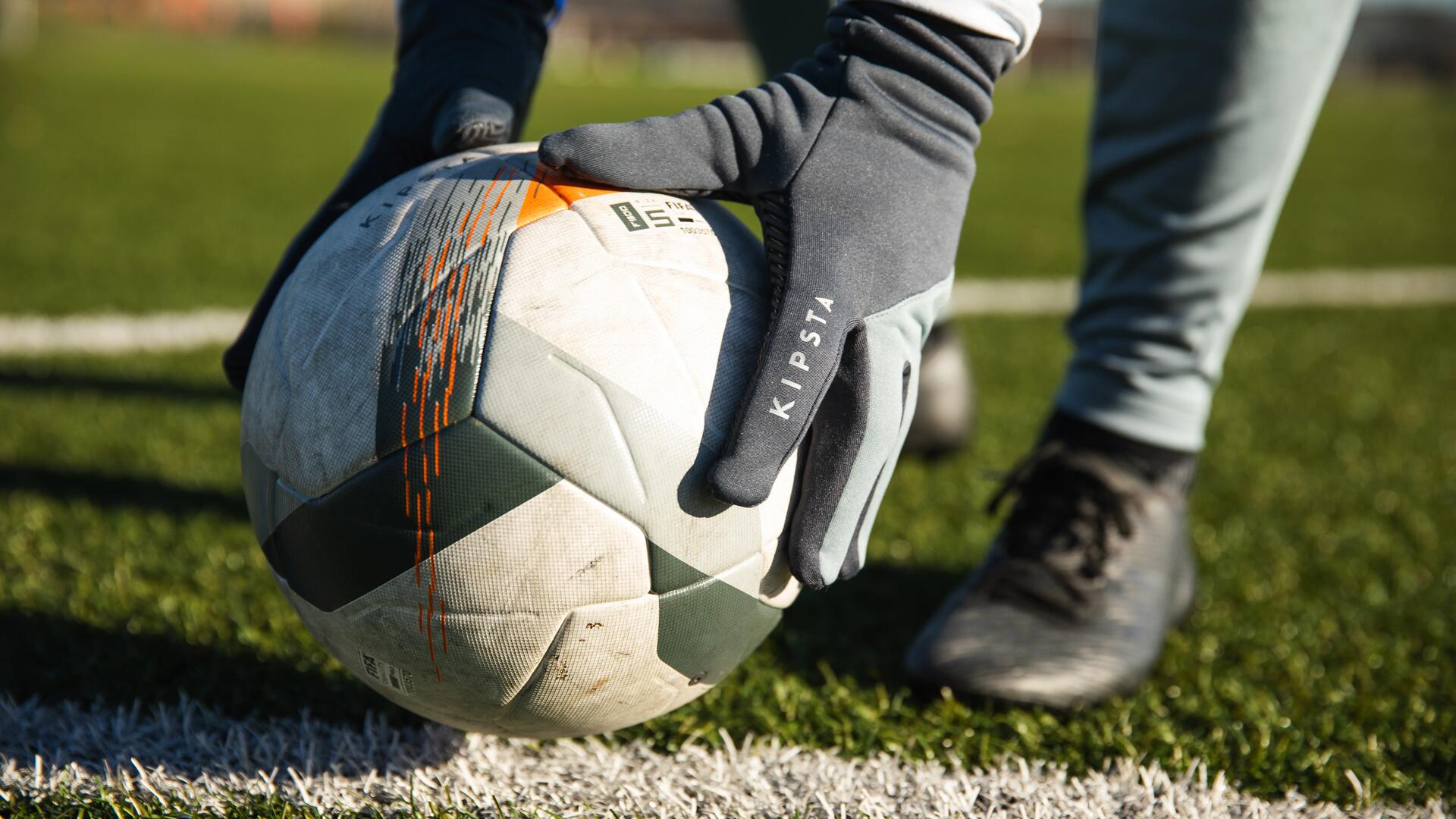 close-up on a player picking up a soccer ball