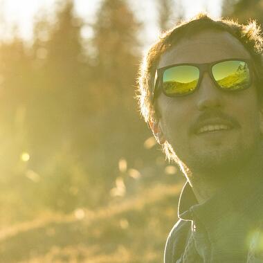 How should you clean your sunglasses?