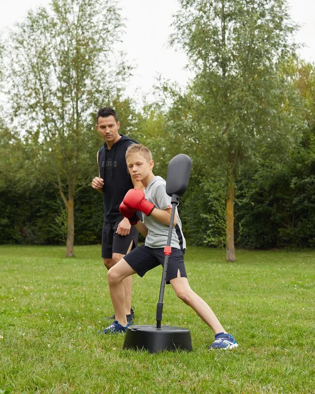 Boy punching the punching ball