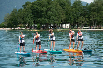 group of people practicing stand up paddle