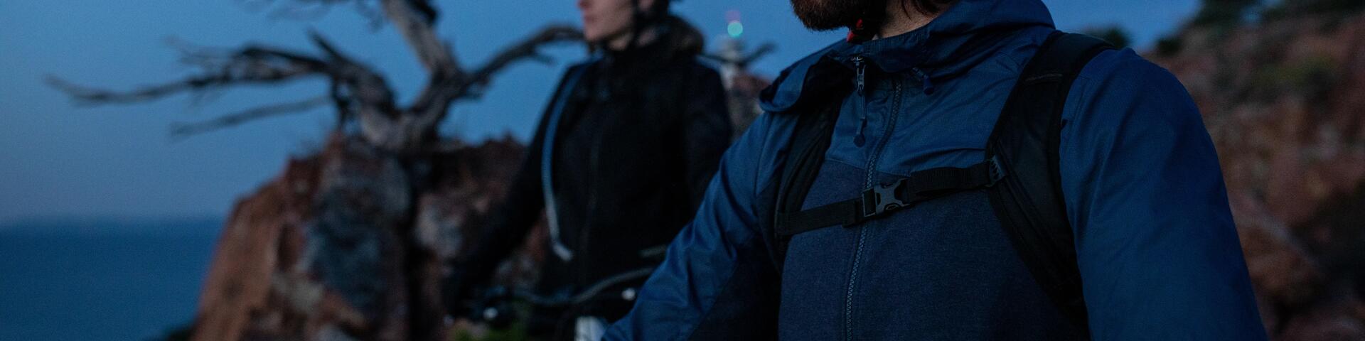 A couple looking out over the landscape during a break on an early morning cycling ride