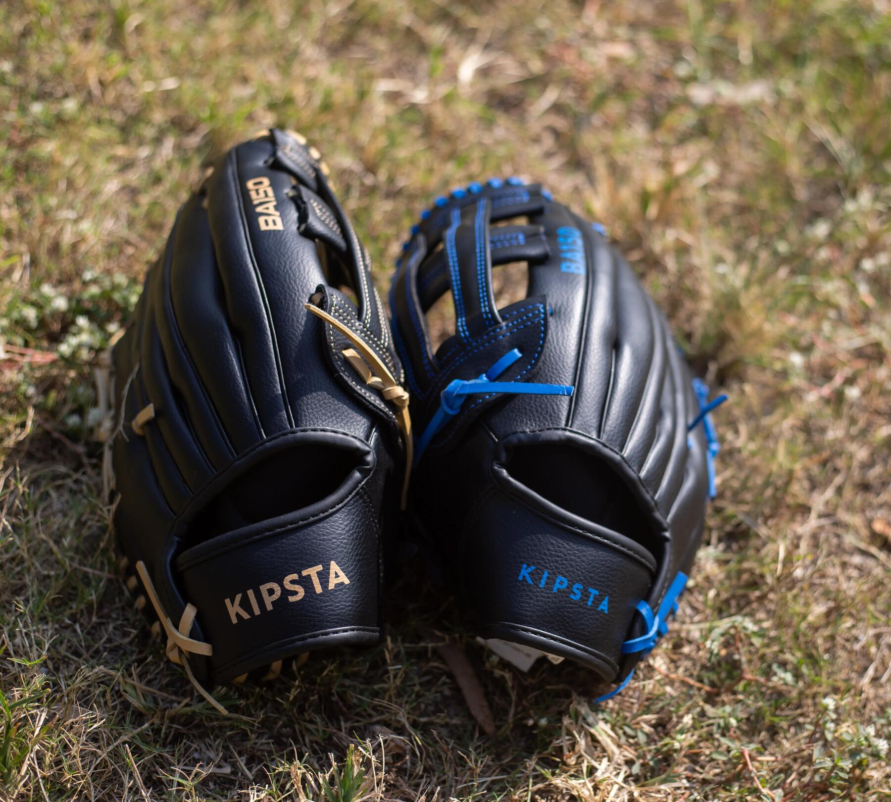 two baseball gloves on the grass