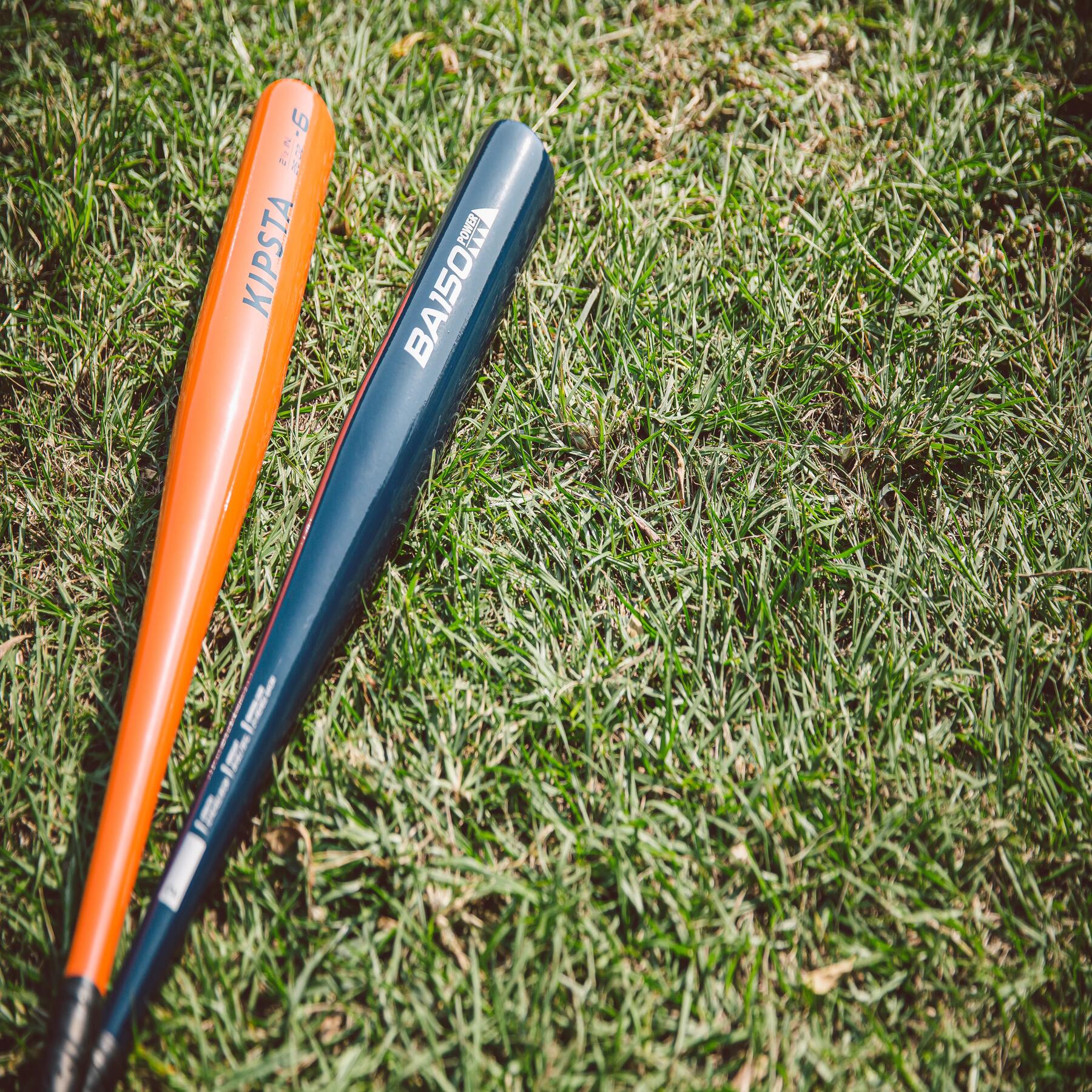 two baseball bats on the grass